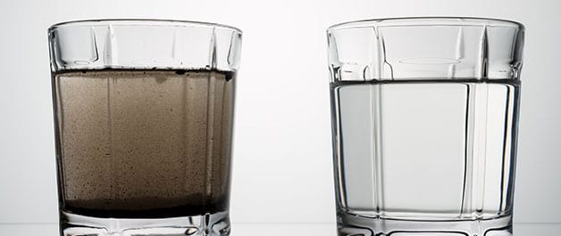 close up glasses with clean and dirty water. concept of water pollution